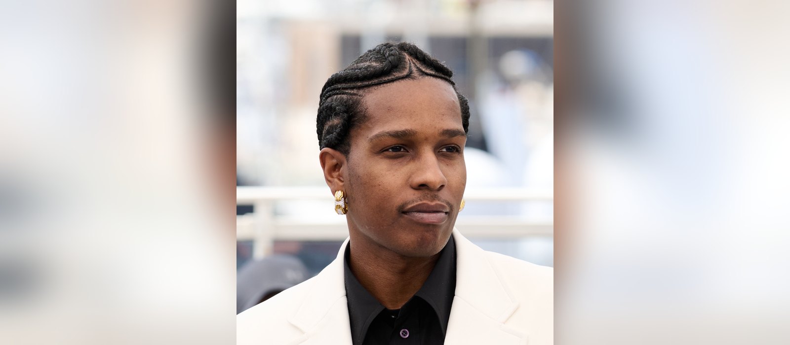 A$AP Rocky in a white jacket and black shirt at a photocall for Highest 2 Lowest at the 2025 Cannes Film Festival