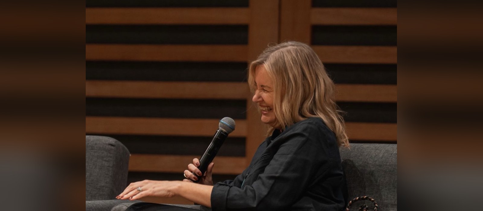 Songwriter Karen Poole laughing on stage during her keynote at the Music Ally Publishing Summit 2026 in London