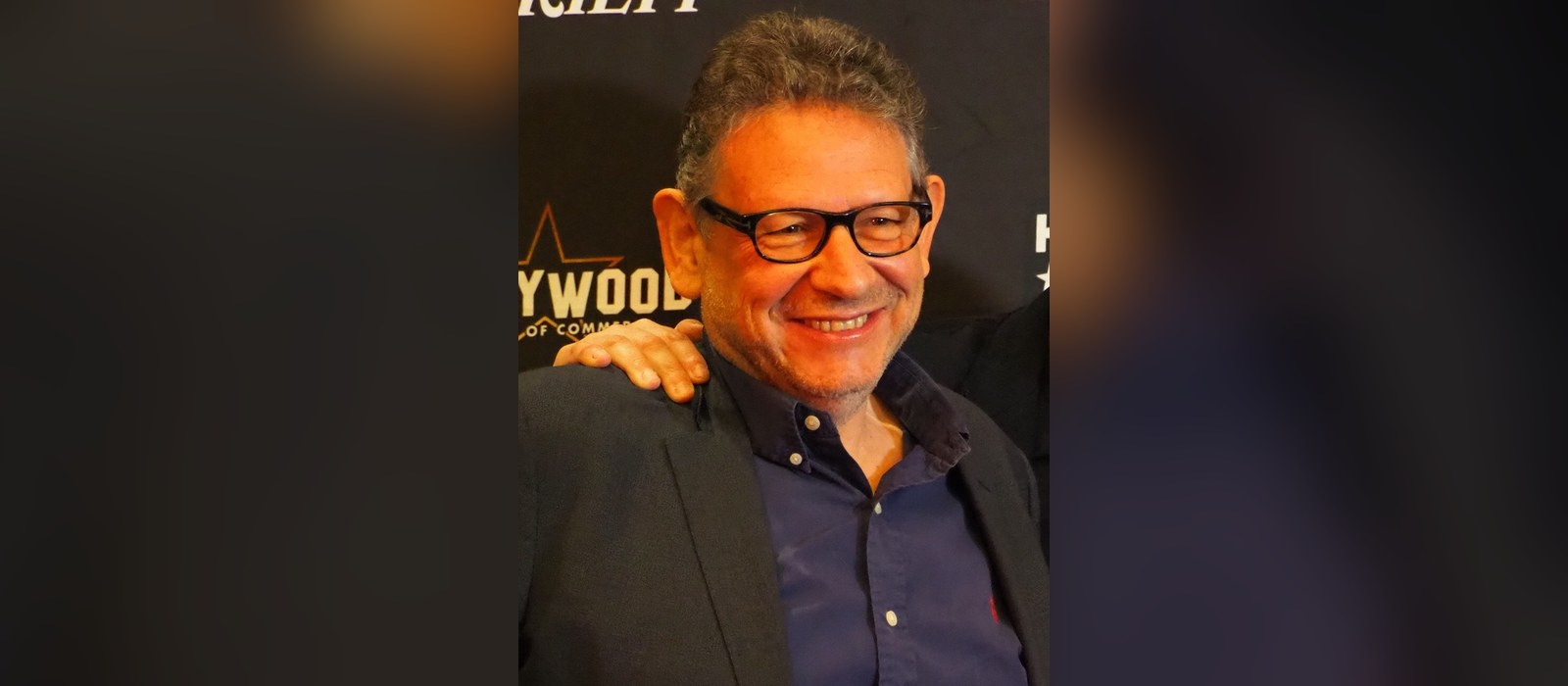 Universal Music Group chairman and CEO Lucian Grainge smiling at a Hollywood Chamber of Commerce event