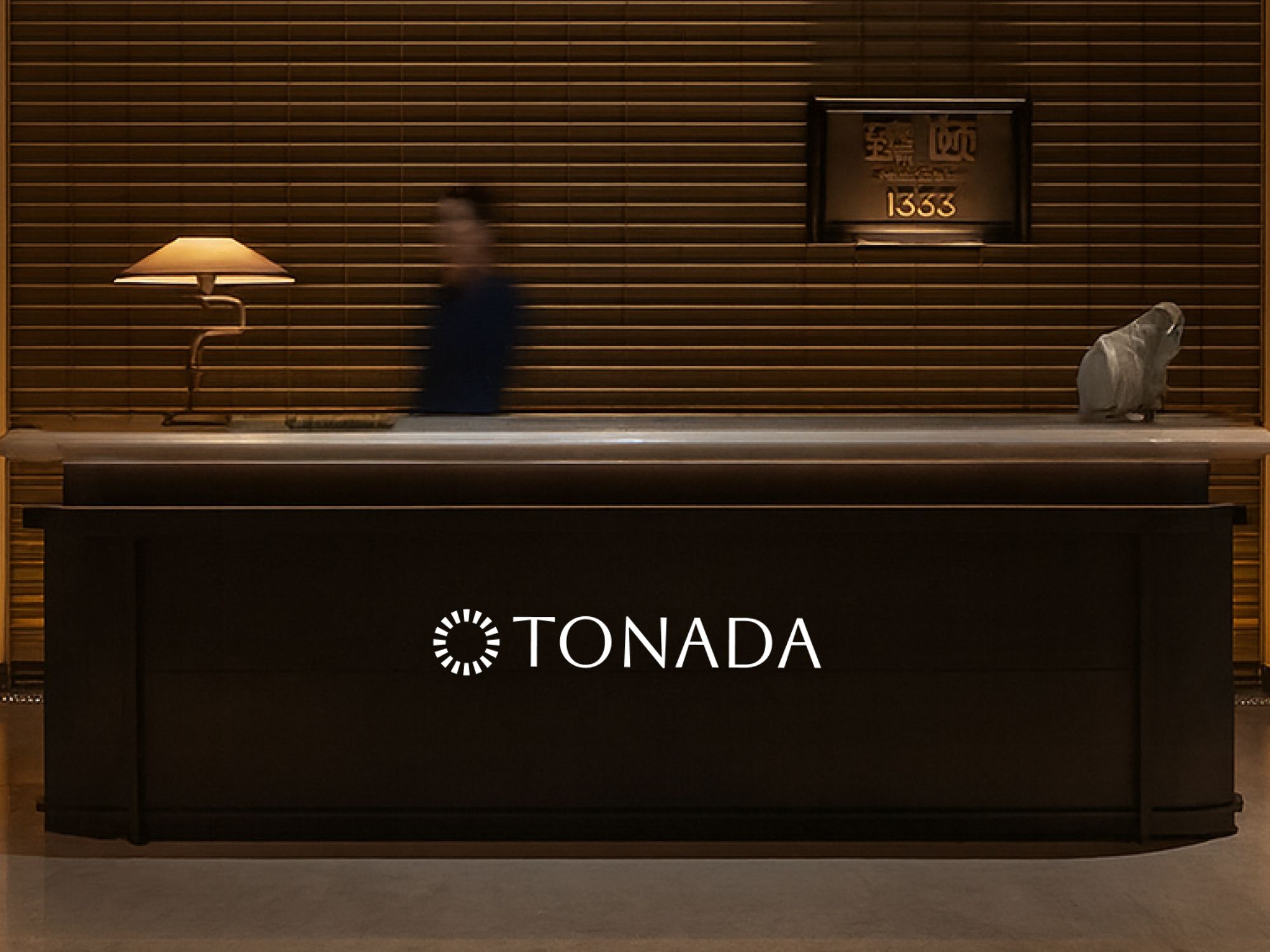 Tonada reception desk with the company logo, illustrating the AI music for retail brand experience