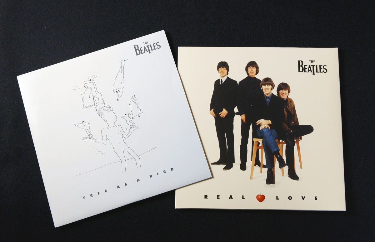 Two Beatles album covers on a dark background. The left cover is "Free as a Bird," featuring minimalist line art of birds and a human figure. The right cover is "Real Love," with a photo of The Beatles dressed in suits, three standing and one seated on a stool, smiling.